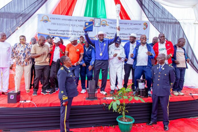 Kisumu County Deputy Governor Dr. Mathew Ochieng’ Owili, County Assembly Speaker Hon. Elisha Oraro and members of the CASA National Governing Council (NGC) celebrate after Kisumu County Assembly received the symbolic host chain for the 7th CASA Games. Photo/CASA